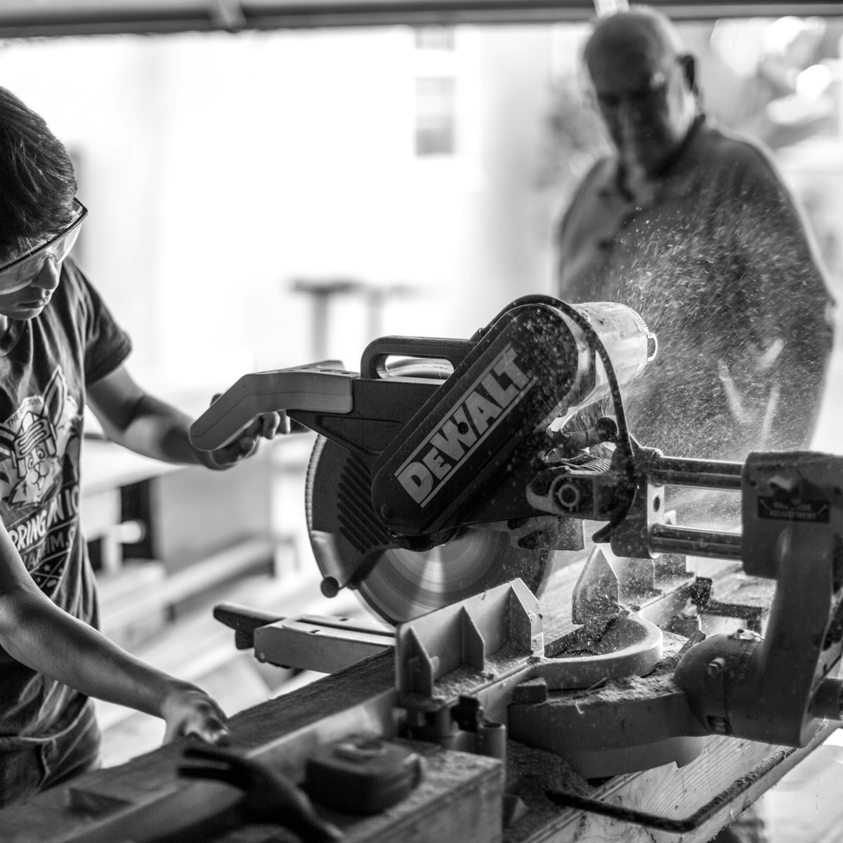 Carpenter planing a length of hardwood in the workshop
